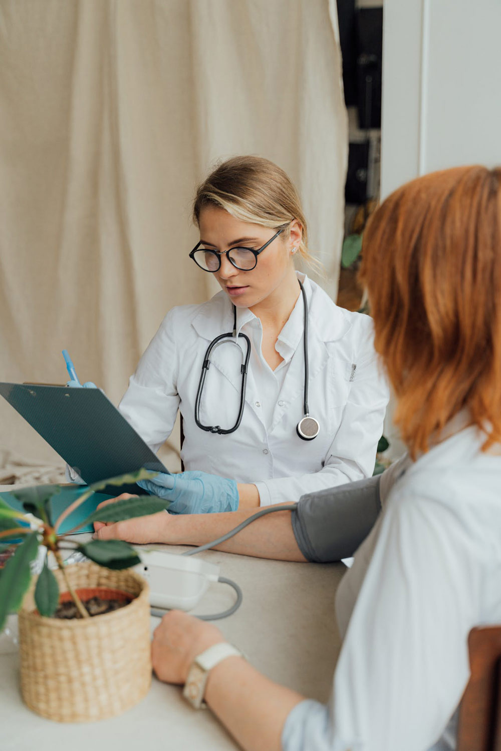 A doctor checking a patient's blood pressure