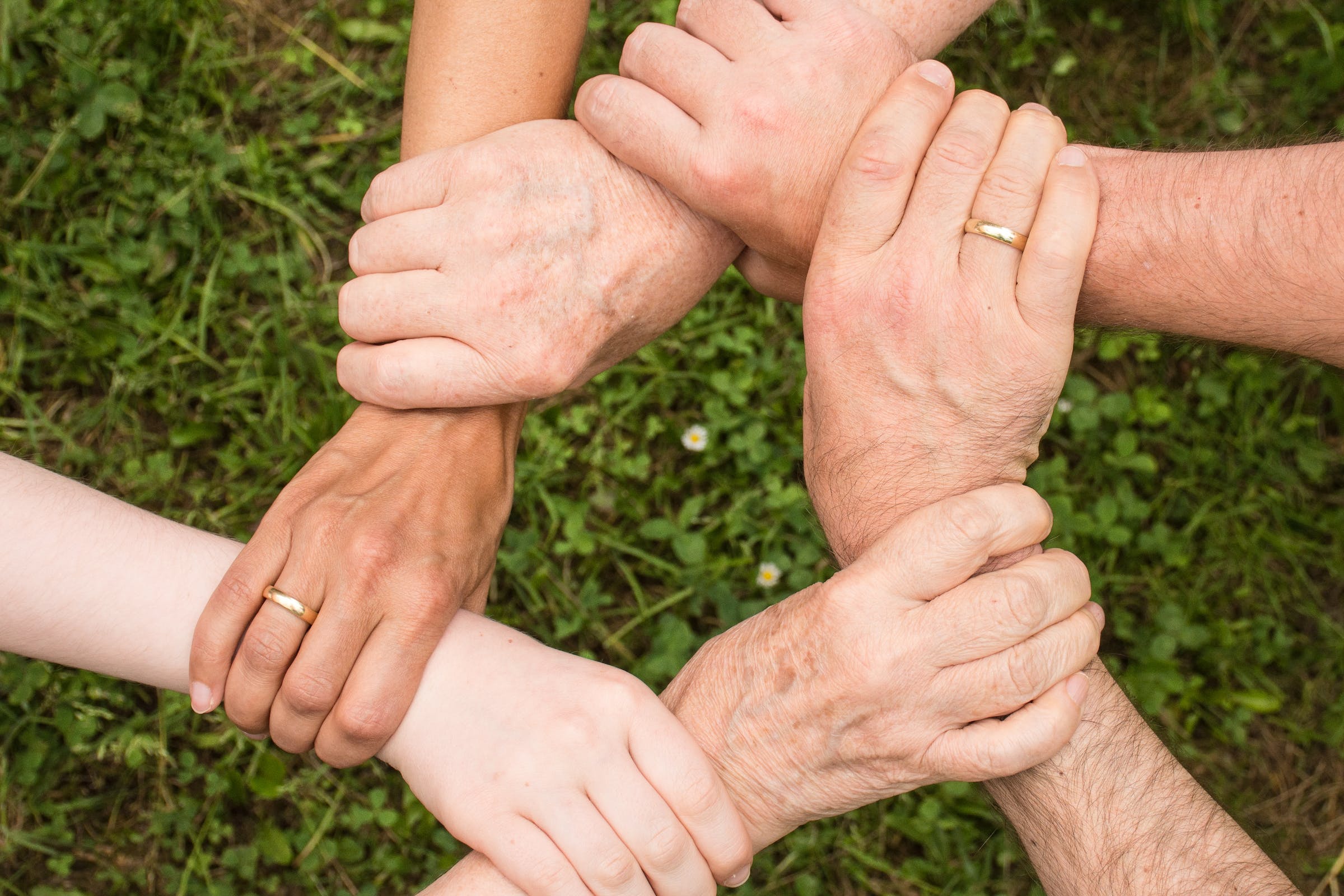 Hands of diverse individuals forming a connected circle